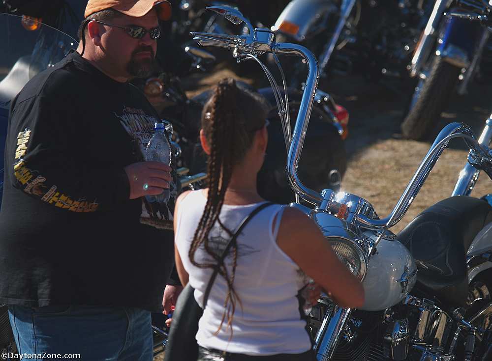 Woman Looks at Motorcycle Chrome